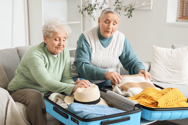 senior female friends packed suitcases home senior female friends packed suitcases home