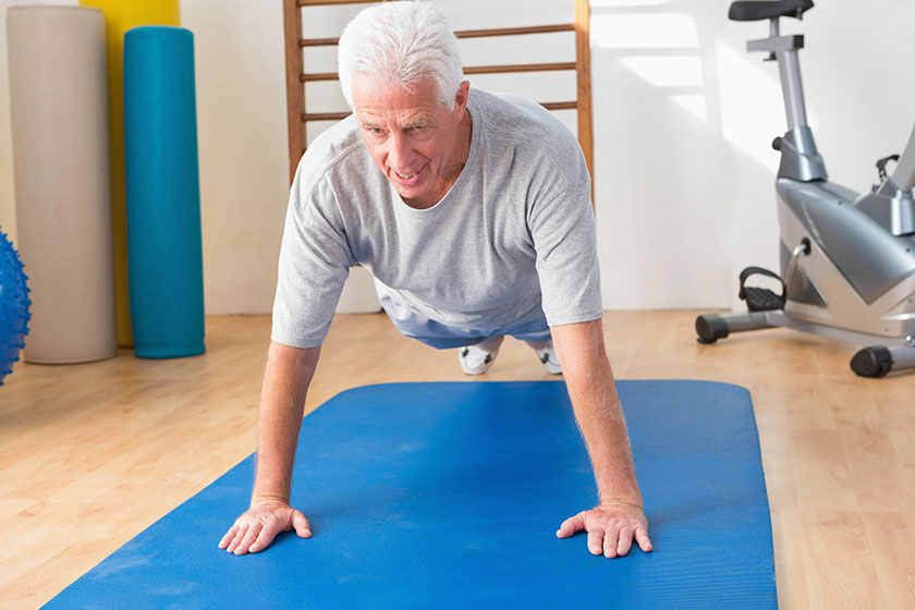 Senior man in plank position