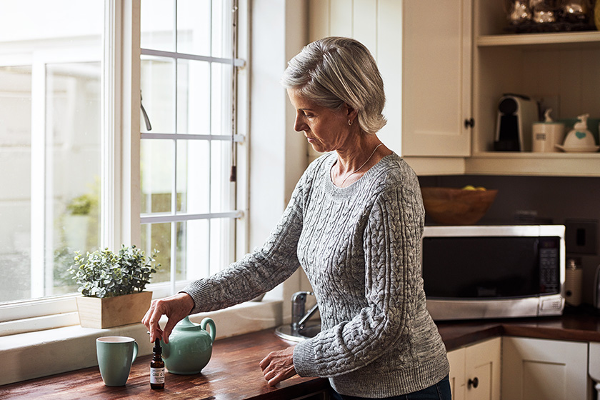 time to take my medicine cropped shot of a relaxed senior woman preparing a cup