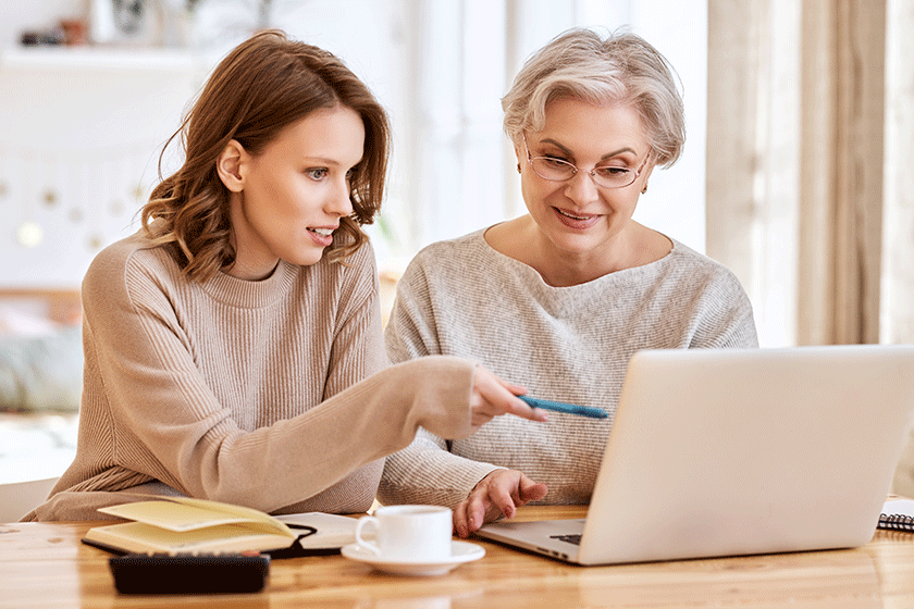 young female casual clothes clarifies information while helping elderly mother young female casual clothes clarifies information while helping elderly mother