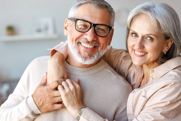 beautiful smiling senior family couple husband and wife looking at camera with love