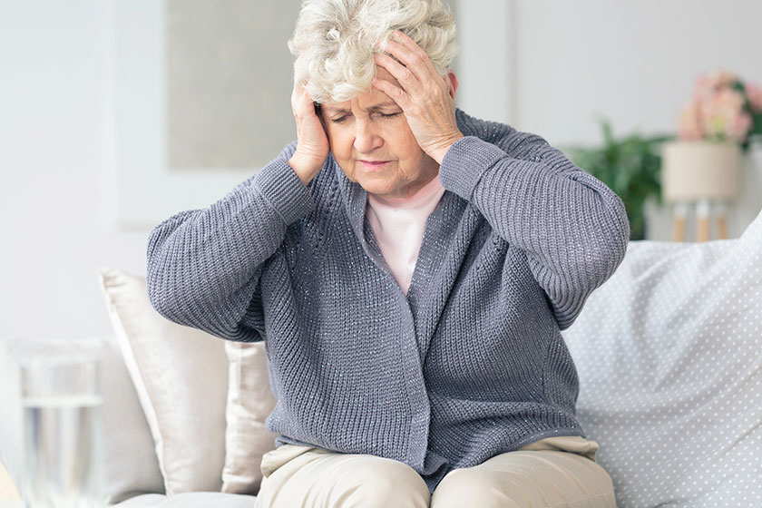 elderly woman having migraine headache