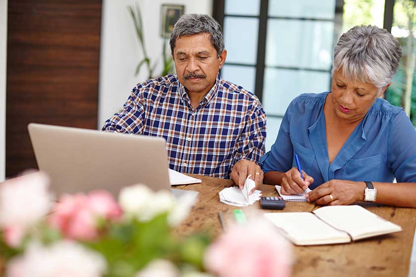 focused finances senior couple working budget together home