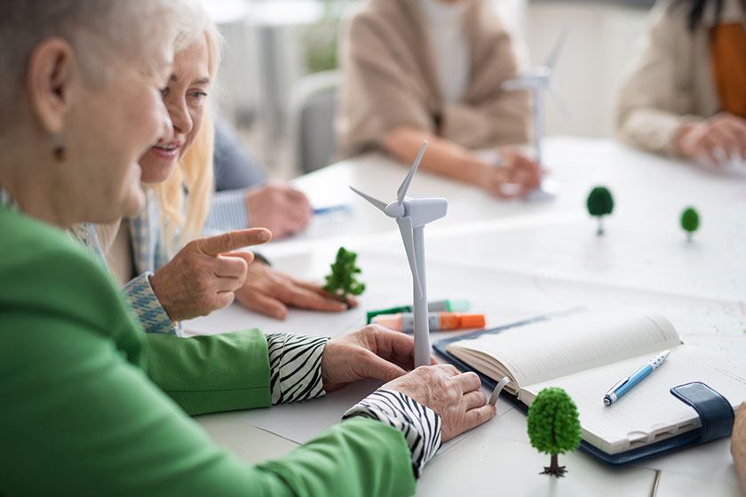 group senior students discussing altenrative energy teacher classroom close