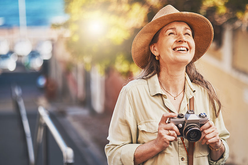 happy photographer tourist taking photo historic building camera smiling carefree