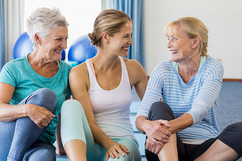 instructor and senior women sitting instructor and senior women sitting