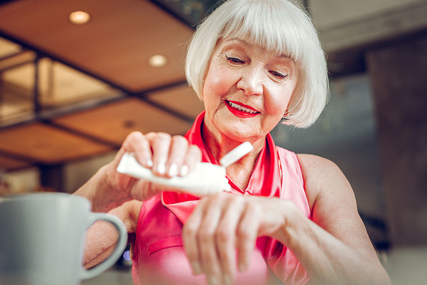 joyful elderly woman looking at her hands