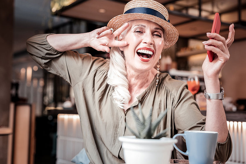 laughing long haired old lady with fashionable outfit