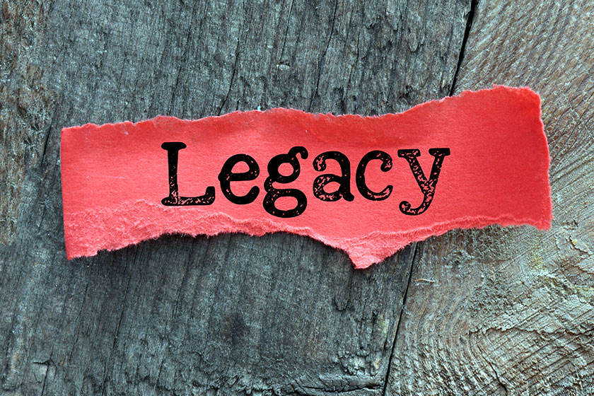 legacy word small red sheet paper wooden background
