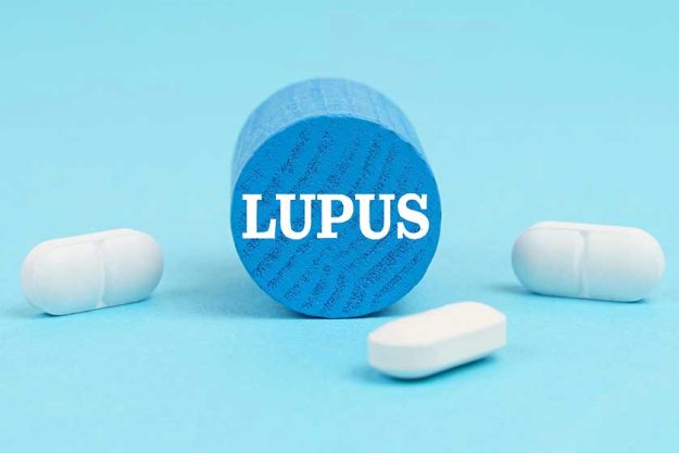 medicine health concept pills lie blue surface wooden blue cylinder