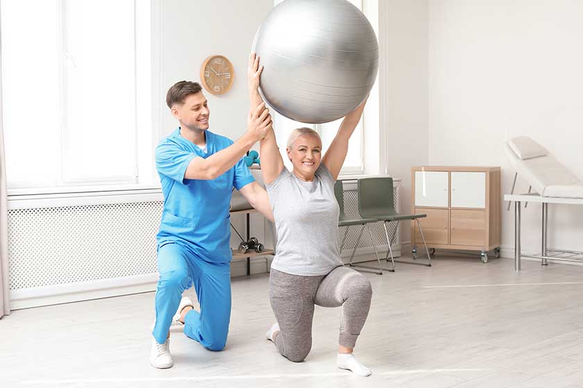 physiotherapist working with patient in clinic rehabilitation therapy