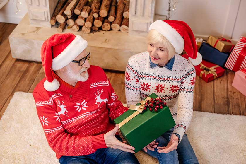 senior couple with christmas present senior couple with christmas present