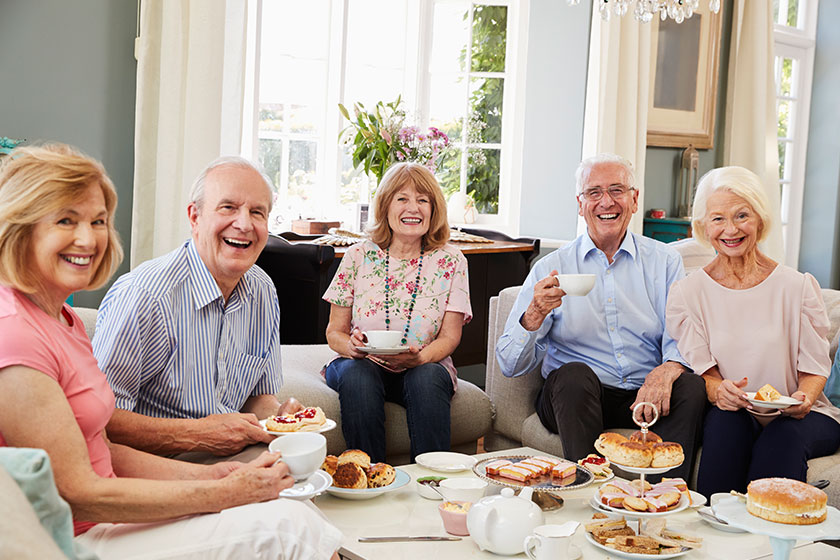 senior friends enjoying afternoon tea senior friends enjoying afternoon tea