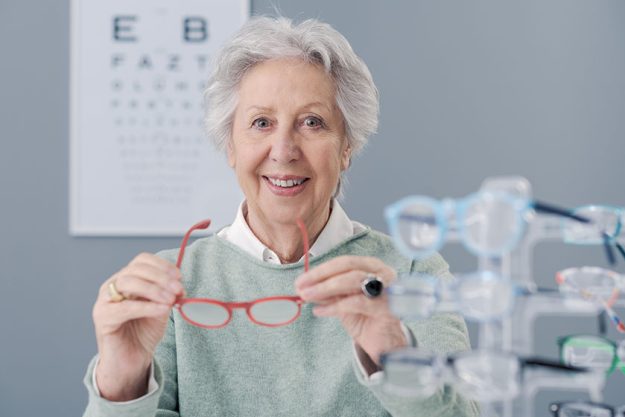 senior woman choosing glasses eyewear shop she holding eyeglasses smiling senior woman choosing glasses eyewear shop she holding eyeglasses smiling