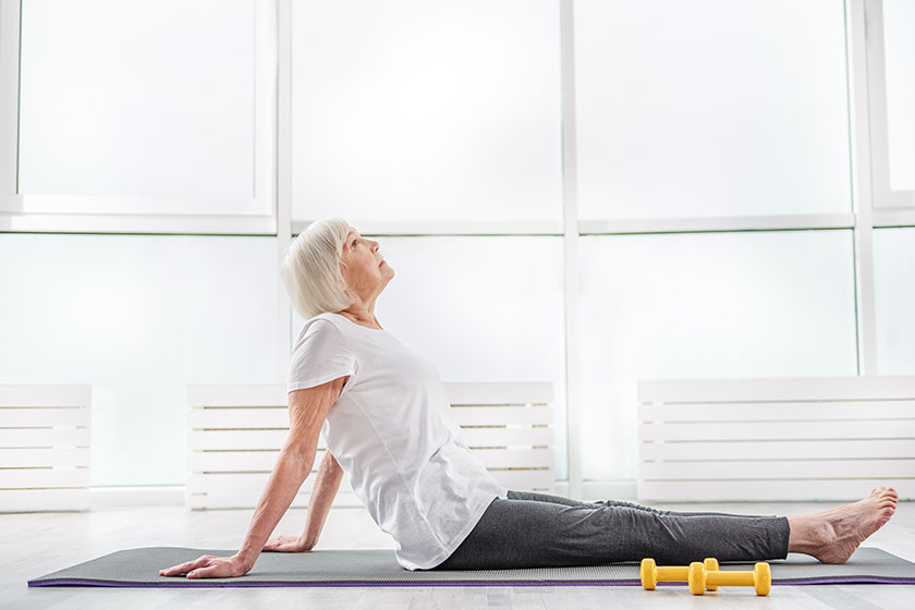 serene old woman exercising in gym