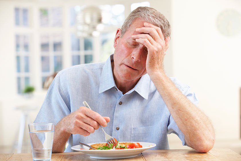 sick man trying to eat