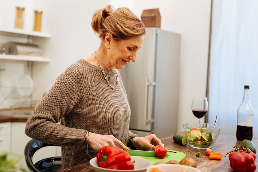 smiling mature lady with tied hair dealing with long knife smiling mature lady with tied hair dealing with long knife