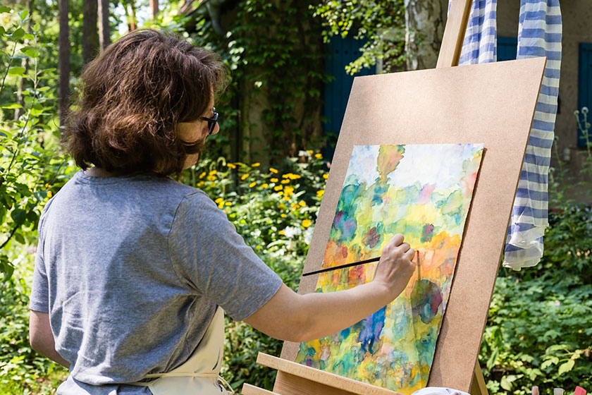woman painting with paint brush