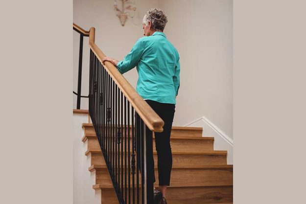 senior woman walking up stairs