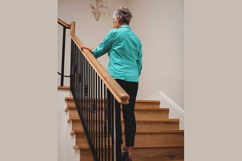 senior woman walking up stairs senior woman walking up stairs