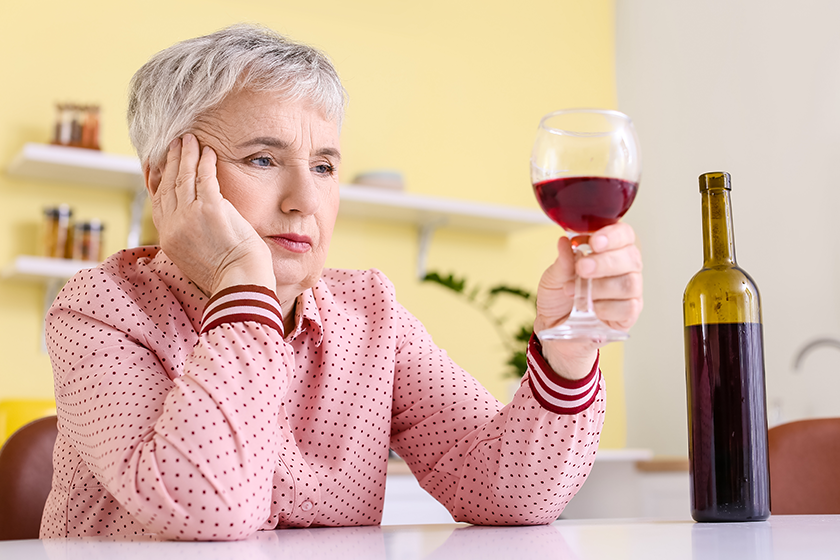 stressed senior woman drinking wine stressed senior woman drinking wine