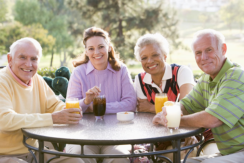 Friends Enjoying A Beverage By A Golf Course