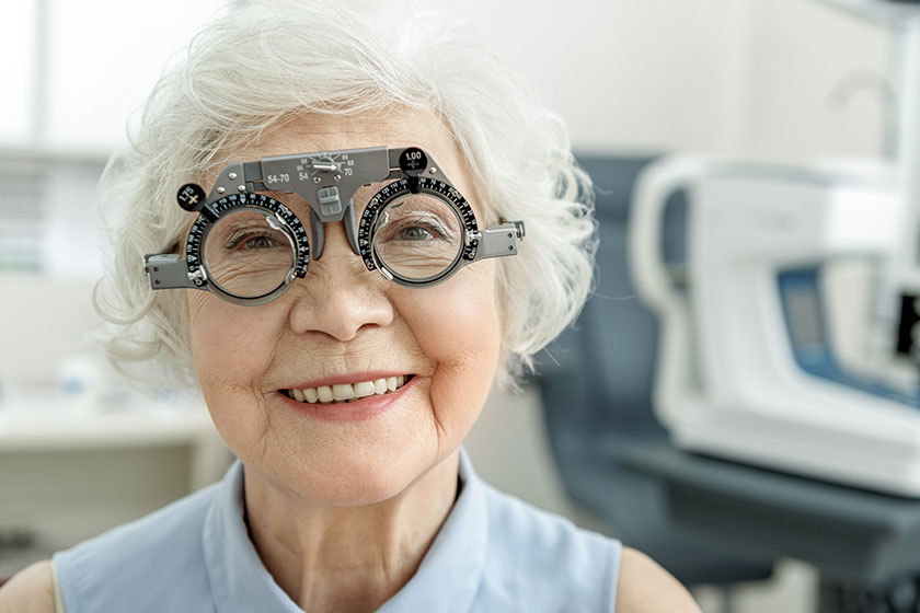 Hilarious smiling old female person checking eyesight Hilarious smiling old female person checking eyesight