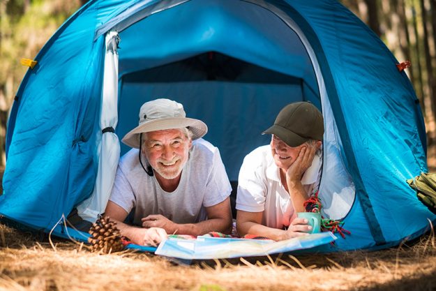 active lifestyle old senior couple enjoy tent camping woods together active lifestyle old senior couple enjoy tent camping woods together