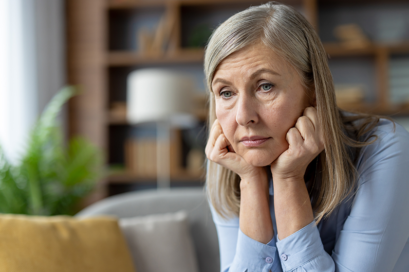 middle aged woman appears worried sitting alone middle aged woman appears worried sitting alone