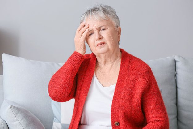 Senior woman suffering from headache at home Senior woman suffering from headache at home