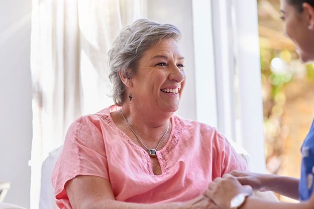 Caregiver, holding hands and woman with support Caregiver, holding hands and woman with support