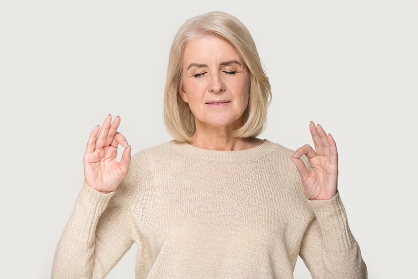 calm senior woman isolated on studio background meditating calm senior woman isolated on studio background meditating