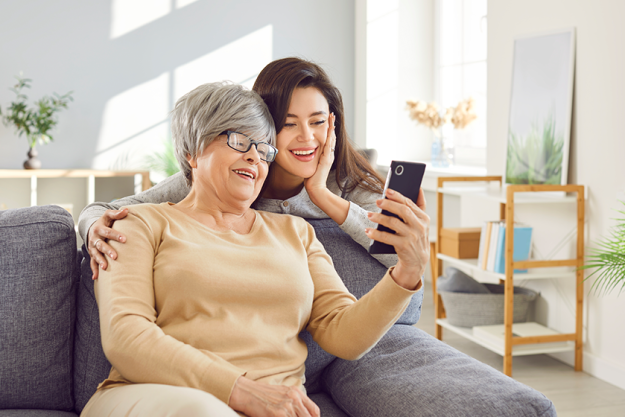 elderly mother adult daughter sitting together