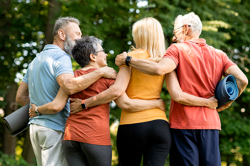 friendship concept group sporty senior people embracing together friendship concept group sporty senior people embracing together