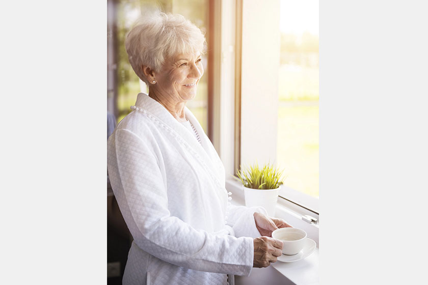 Mature woman near window
