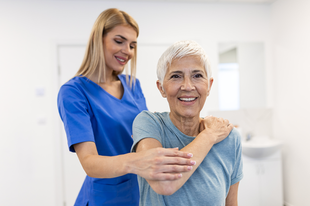 physiotherapist working senior female patient her
