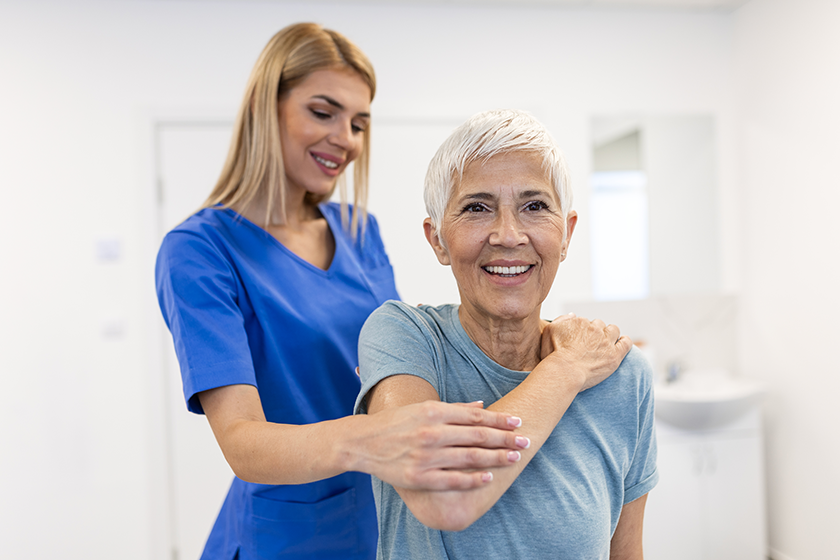 physiotherapist working senior female patient her
