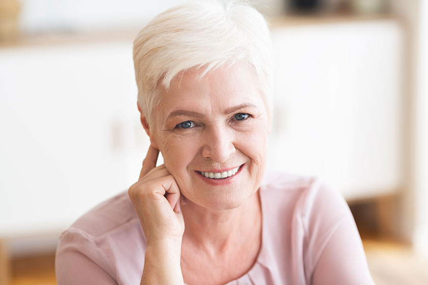 Portrait of attractive aged business lady smiling at camera