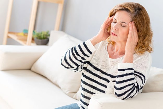 Senior woman feels pain in head Senior woman feels pain in head