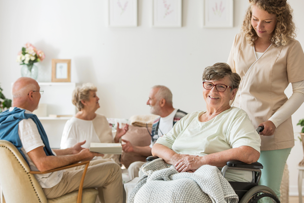 senior woman on wheelchair with professional caregiver