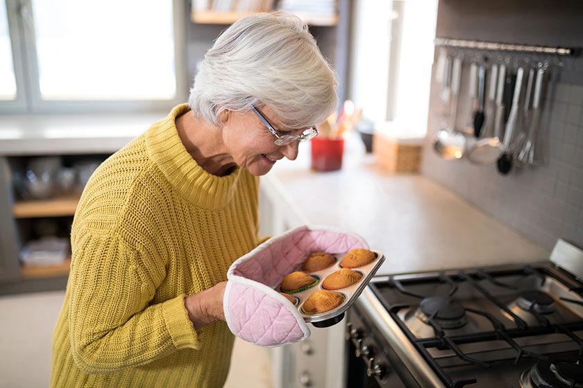 Senior women holding freshly baked muffins