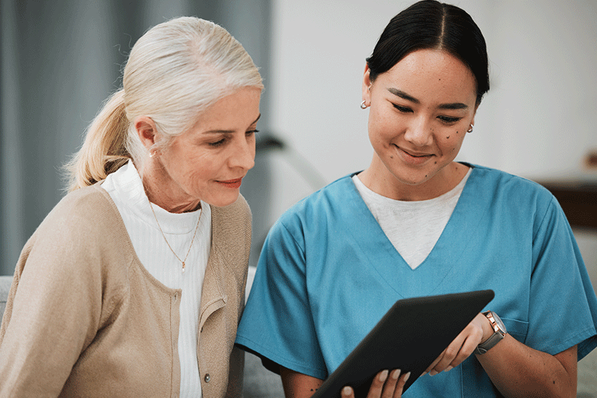 tablet news nurse old woman consulting surgery medical test results