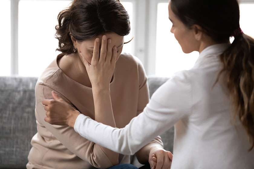 Compassionate kind young woman supporting depressed unhappy older mother