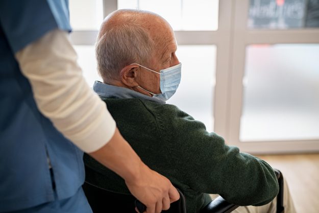 Depressed,Senior,Patient,Sitting,On,Wheelchair,And,Wearing,Protective,Face Depressed,Senior,Patient,Sitting,On,Wheelchair,And,Wearing,Protective,Face
