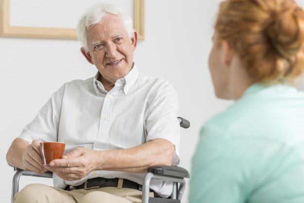 Elderly,Man,On,A,Wheelchair,Drinking,Coffee,With,His,Carer Elderly,Man,On,A,Wheelchair,Drinking,Coffee,With,His,Carer