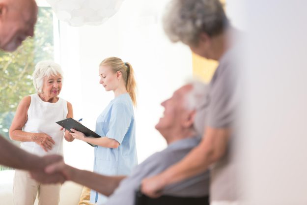 Nurse,Sharing,Health,Information,With,Senior,Patient,While,Standing,In Nurse,Sharing,Health,Information,With,Senior,Patient,While,Standing,In