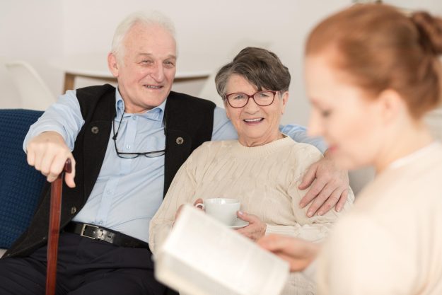 Professional,Caregiver,Assisting,Senior,Couple,In,Daily,Activities,At,Home Professional,Caregiver,Assisting,Senior,Couple,In,Daily,Activities,At,Home