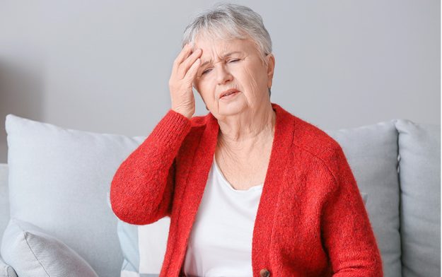 Senior woman suffering from headache at home Senior woman suffering from headache at home