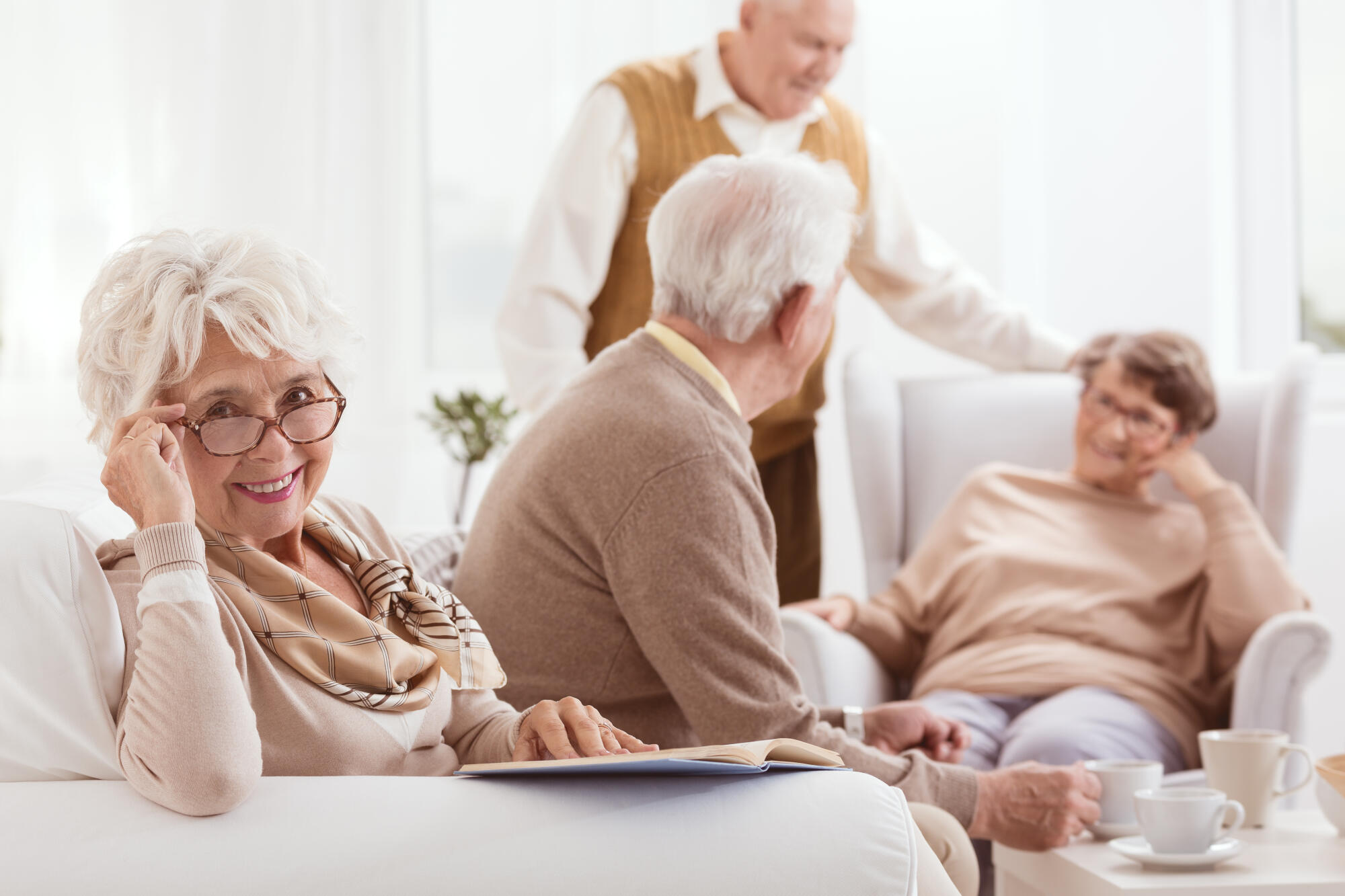 Smiling,Grandmother,Reads,Book,In,Brown,Glasses,During,Meeting