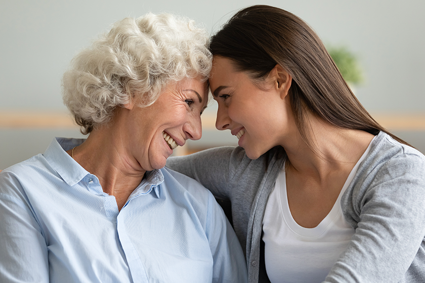 adult granddaughter elderly grandmother hugging